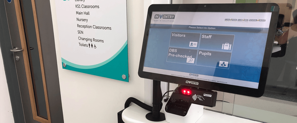 An InVentry sign-in system on a screen in a school reception.