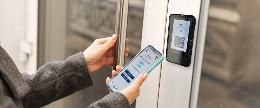 Woman using a mobile phone to operate an InVentry access control system.