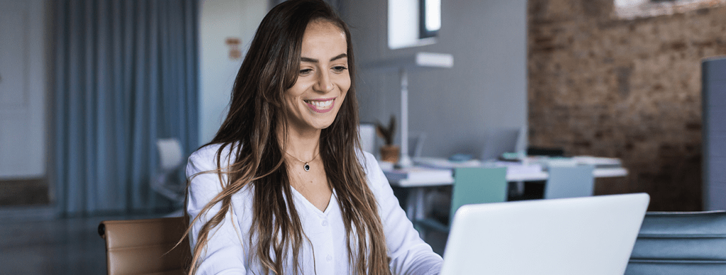 Woman looking at laptop with ERP System on it