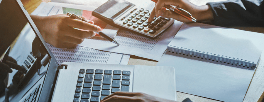 hands holding a calculator and using a calculator