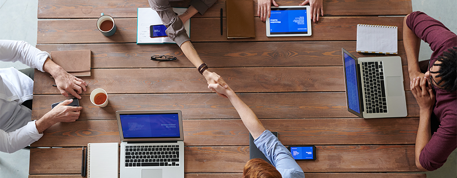 Meeting at table with laptops