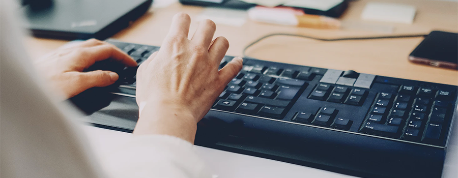 Person with keyboard typing into an ERP System
