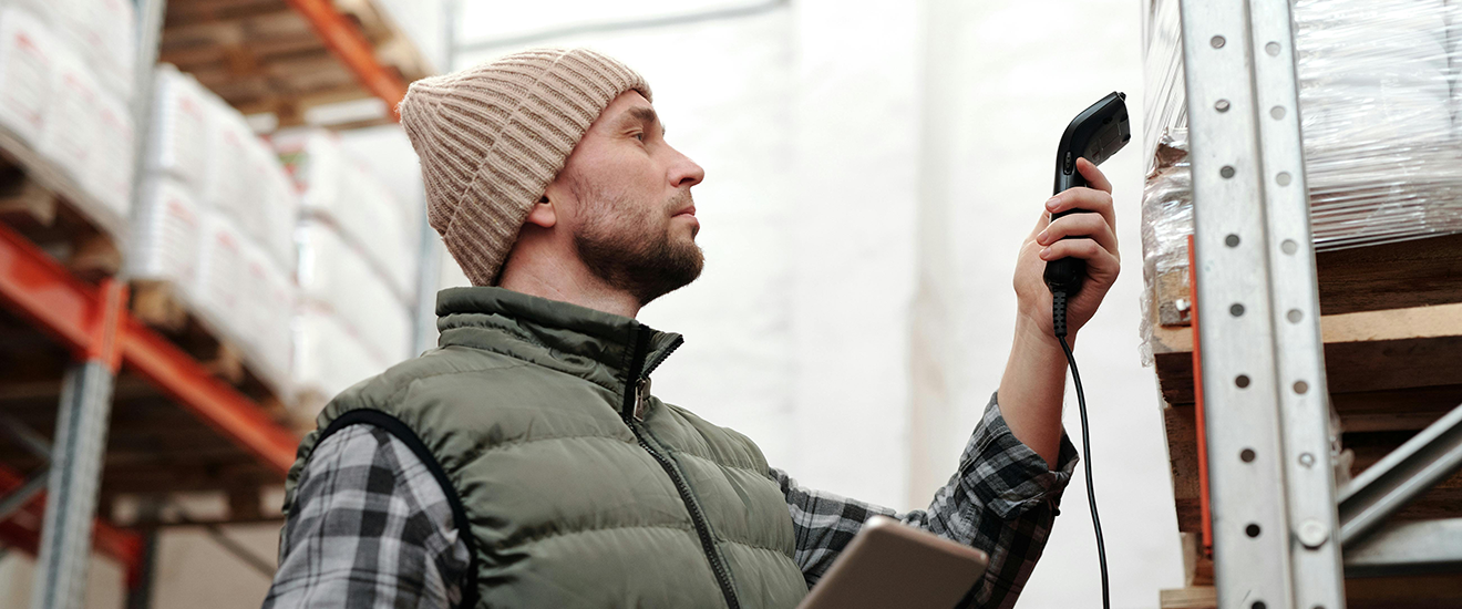 Man Scanning Boxes in Warehouse