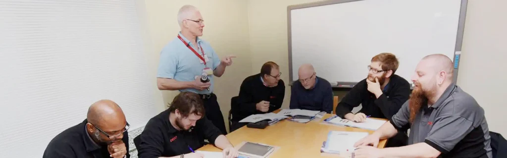 People sitting round a table in a training room for Gas Safe Consultants